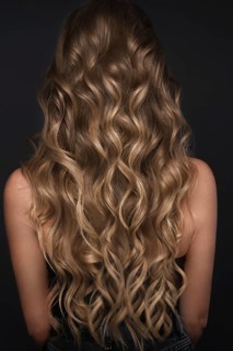A closeup view of a bunch of shiny curls blond hair
