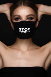 Portrait of a beautiful woman in a black mask stop covid and classic makeup. Mask mode during the covid pandemic