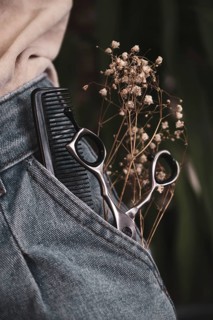 Hairdressing tools close-up in jeans with flowers