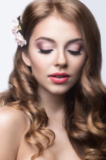 Portrait of a beautiful woman in the image of the bride with flowers in her hair. Picture taken in the studio on a black background
