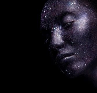 Portrait of beautiful woman with art glitter makeup on her face