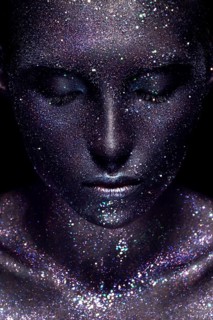 Portrait of beautiful woman with art glitter makeup on her face