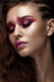 Brunette girl with a creative hairstyle braids