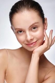 Portrait of beautiful woman with light natural make-up and perfect skin