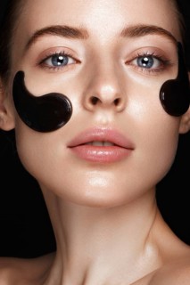 Beautiful fresh girl with cosmetic patches under the eyes