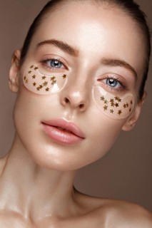 Beautiful fresh girl with cosmetic patches under the eyes