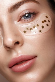 Beautiful fresh girl with cosmetic patches under the eyes