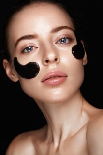 Beautiful fresh girl with cosmetic patches under the eyes