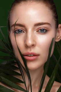 Beautiful fresh girl with cosmetic cream on the face
