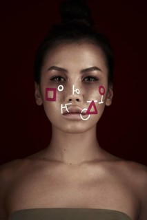 Portrait of a beautiful woman with an abstract pattern on her face. Creative makeup