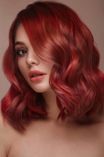 Beautiful girl with multi-colored hair and classic make-up and hairstyle. Beauty face. Photo taken in the studio