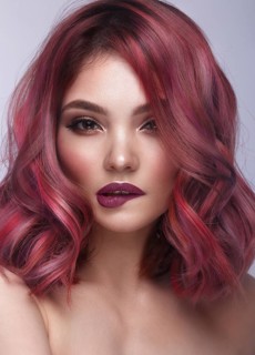 Beautiful girl with multi-colored hair and classic make-up and hairstyle. Beauty face. Photo taken in the studio