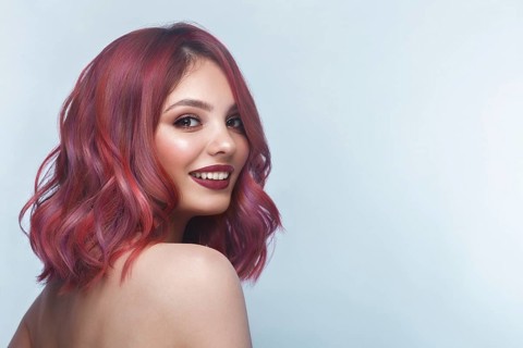 Beautiful girl with multi-colored hair and classic make-up and hairstyle. Beauty face. Photo taken in the studio