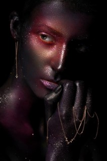Beautiful girl with art space makeup on her face and body. Glitter Face. Photo taken in the studio