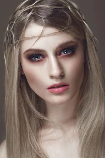 Beautiful fashion woman with creative make-up and hairstyle. The beauty of the face. Photos shot in the studio