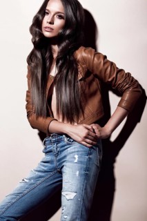 Attractive beautiful fashionable woman with curls unusual in everyday clothes
