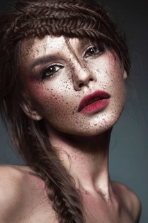 Beautiful strange girl with creative art make-up. Beauty face. Photo taken in studio