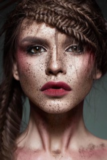 Beautiful strange girl with creative art make-up. Beauty face. Photo taken in studio