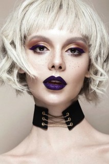 Beautiful woman with art makeup and a fashionable hair. The beauty of the face. Portrait shot in studio