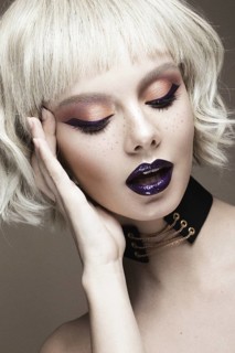 Beautiful woman with art makeup and a fashionable hair. The beauty of the face. Portrait shot in studio
