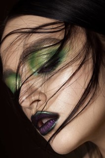 Beautiful girl with spring green makeup and vampire lips. beauty face. Photos shot in studio