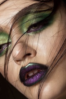 Beautiful girl with spring green makeup and vampire lips. beauty face. Photos shot in studio