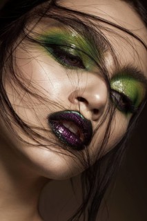 Beautiful girl with spring green makeup and vampire lips. beauty face. Photos shot in studio