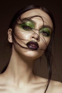 Beautiful girl with spring green makeup and vampire lips. beauty face. Photos shot in studio