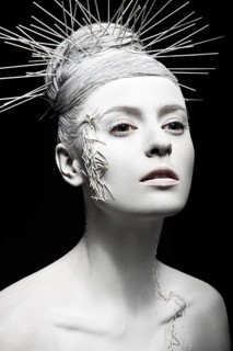 Art fashion girl with white skin and unusual hairstyle. Creative art beauty. Picture taken in the studio on a black background