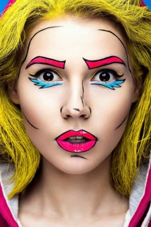 Photo of surprised young woman with professional comic pop art make-up. Creative beauty style. Photos shot in studio