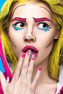 Photo of surprised young woman with professional comic pop art make-up and design manicure. Creative beauty style and nails. Photos shot in studio