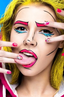 Photo of surprised young woman with professional comic pop art make-up and design manicure. Creative beauty style and nails. Photos shot in studio