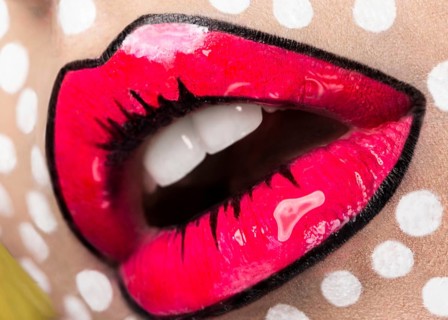 Photo of young woman with professional comic pop art make-up. Creative beauty style. Photos shot in studio. Close up lips