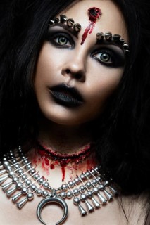 Demon girl with a bullet in the head and her throat cut. An image for Halloween. Photos shot in studio
