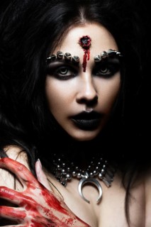 Demon girl with a bullet in the head and her throat cut. An image for Halloween. Photos shot in studio