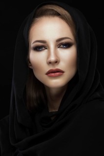 Beautiful girl in the Arab scarf with oriental make-up. Beauty face. Photos shot in the studio