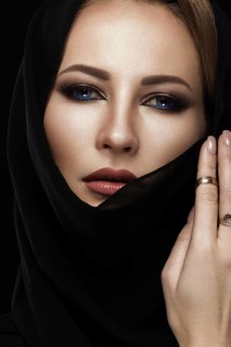 Beautiful girl in the Arab scarf with oriental make-up. Beauty face. Photos shot in the studio