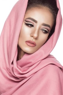 Beautiful girl in the Arab scarf with oriental make-up. Beauty face. Photos shot in the studio