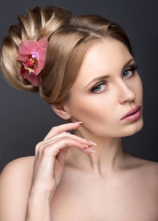 Portrait of a beautiful woman in the image of the bride with flowers in her hair. Picture taken in the studio on a black background