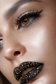 Beautiful girl with black creative art make-up. Beauty face. Photos shot in studio