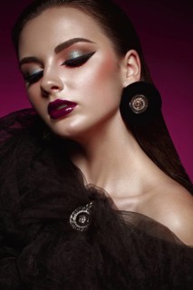 Beautiful girl with bright creative make-up and graphic arrows. Beauty face. Photos shot in studio