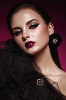 Beautiful girl with bright creative make-up and graphic arrows. Beauty face. Photos shot in studio