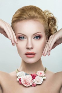 Portrait of a beautiful girl with pink flowers on her head. Photo shot in the Studio on a white background