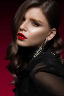 Beautiful girl with red lips and golden eyebrows