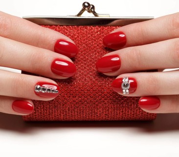 Bright festive red manicure on female hands. Nails design