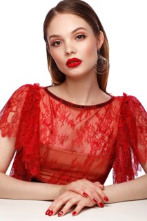 Beautiful girl in red dress with classic make-up and red manicure. Beauty face. Photo taken in the studio