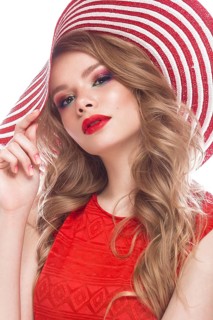 Bright cheerful girl in a summer hat