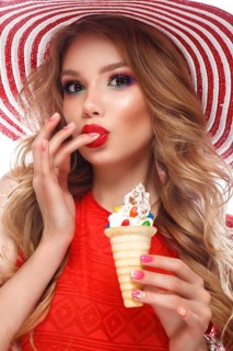 Bright cheerful girl in a summer hat