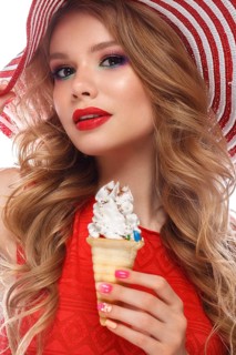 Bright cheerful girl in a summer hat