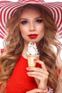 Bright cheerful girl in a summer hat